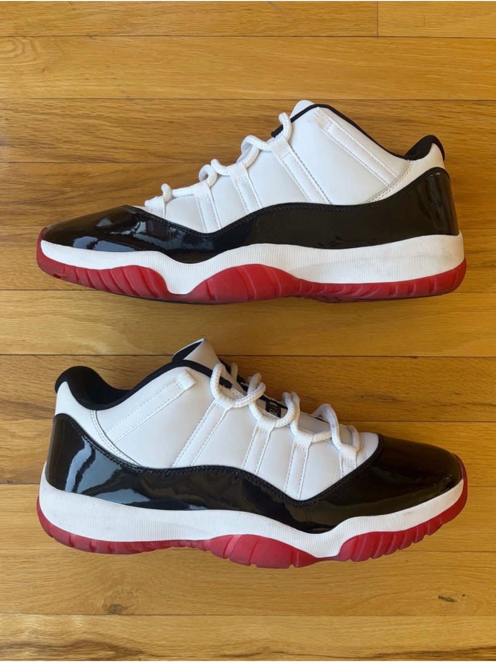 Air Jordan 11 Retro Low Sneakers in White, Black & Red